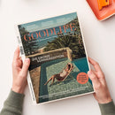 Titelbild des Magazins „GOODLIFE – Das Magazin für Wohnen & Design, Kultur & Kulinarik, Stil & Reise“ mit der Aufschrift „DIE GROSSE SOMMEREDITION“. Abgebildet ist eine weibliche Person im gestreiften Badeanzug, die auf einer Liege in einem Pool entspannt, umgeben von Steinmauern, Palmen und Blick auf das Meer; unten weitere Texte u. a. zu Kopenhagen, Mykonos und Louis Vuitton.