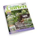 Titelblatt des Gartenmagazins „mein schöner Garten“ Juli 2026 mit Foto einer sommerlichen Gartenterrasse, umgeben von weißen Blüten und grünen Sträuchern, brauner Eckbank mit hellen Kissen, Holztisch mit Kerzen und Glas. Texte auf dem Cover: „Weiße Blüten im Sommergarten“, „Ideen mit Wasser“, „Jetzt schon ernte­reif“, „Alles Wichtige in diesem Monat“ sowie Webadresse www.mein-schoener-garten.de.