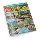 Titelbild der Zeitschrift „Lisa Wohnen & Dekorieren“, Ausgabe August 2026, mit gelber Überschrift auf blauem Hintergrund. Im Mittelpunkt eine sommerlich gestaltete Terrasse mit Holzdeck, hellen Sofas, Pflanzen und Dekoelementen. Schlagzeilen u. a. „Meine Wohlfühl-Oase“, „Sommer-Trend: Streifen“, „Mediterrane Küche“, und „Ordnung im Kinderzimmer“. Links unten eine Frau mit hellblauer Bluse und Tablett.