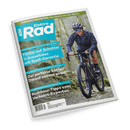 Titelbild der Zeitschrift „Elektro Rad“ mit einer lächelnden Person auf einem schwarzen Gravelbike im Wald, bekleidet mit blau gemustertem Hemd, Helm und Sonnenbrille; sichtbare Schlagzeilen: „Flotter auf Schotter – 11 Gravelbikes mit Spaß-Garantie“, „Der perfekte Sattel? – Darauf kommt es an“, „Rushhour-Tipps vom Verkehrs-Experten“, Magazinlogo oben links, grüne Kopfzeile: „EUROBIKE-NEUHEITEN: Das Beste von der Messe“.