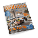 Titelblatt der Wohnzeitschrift „zuhause wohnen“ Ausgabe Juli 2026 mit dem Untertitel „Wie Wohnen wirklich glücklich macht“, zeigt ein helles Wohnzimmer mit grauer Eckcouch, vielen beigefarbenen und cremefarbenen Kissen, Holztisch mit Dekoration, Wandspiegel und großen Fenstern. Sichtbare Textausschnitte: „Kleine Räume, VIEL PLATZ“, „ZAUBERN MIT TAPETEN“, „LUST AUF SÜDEN“, „ZU GEWINNEN“.