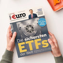 Auf weißer Fläche hält eine Person mit beiden Händen ein schräg liegendes Wirtschaftsmagazin mit dunkelblauem Cover, Tresorabbildung und Porträt eines Mannes im Anzug. Sichtbare Texte: „euro“, „DAS MAGAZIN FÜR WIRTSCHAFT UND GELD“, „www.boerse-online.de“, „Lindner exklusiv“, „Die sichersten ETFs der Welt“ und „GEPRÜFT: 60 %, 90 %, 130 % GEWINN“; oben rechts liegt ein orangefarbenes Objekt.