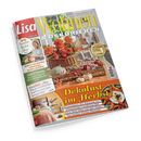Schräg fotografiertes Magazincover „Lisa Wohnen & Dekorieren“ vor schwarzem Hintergrund mit einem Herbststillleben aus orangefarbenen Blumen im Weidenkorb, Kürbissen, Gläsern und Dekoration auf einem Holztisch. Eine weibliche Person ist links abgebildet; sichtbare Texte: „58 kreative Herbst-Ideen“, „Endlich Ordnung“, „Wohlfühl-Mix“ und „Dekolust im Herbst“.