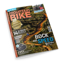 Schräg abgebildetes Magazin „mountainBIKE“ mit orangefarbenem Rand vor schwarzem Hintergrund. Das Cover zeigt einen bewaldeten Mountainbike-Trail mit einer radfahrenden Person, drei Fahrrädern auf einem Kupplungsträger sowie einem abgebildeten „GOBAO X1R“-Motor; sichtbare Texte: „E-MYTB“, „BIKE“, „ALLES IST FAHRBAR“, „BOCK auf SPEED“, „EUROBIKE Kompakt“ und „E-CVT“.