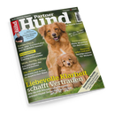 Schräg vor schwarzem Hintergrund liegt das grün gestaltete Zeitschriftencover „Partner Hund“ mit einem golden-braunen Hund und einem kleineren Welpen im Vordergrund. Abgebildet sind außerdem eine männliche Person sowie die Texte „Kleine Hunde erziehen“, „Fakten-Check Nass- oder Trockenfutter“ und „Liebevolle Klarheit schafft Vertrauen“.